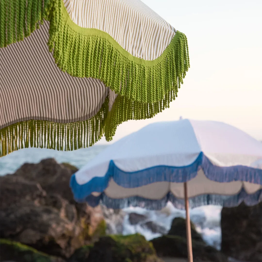 Green cotton fringe on beach parasol – nature-inspired coastal decor